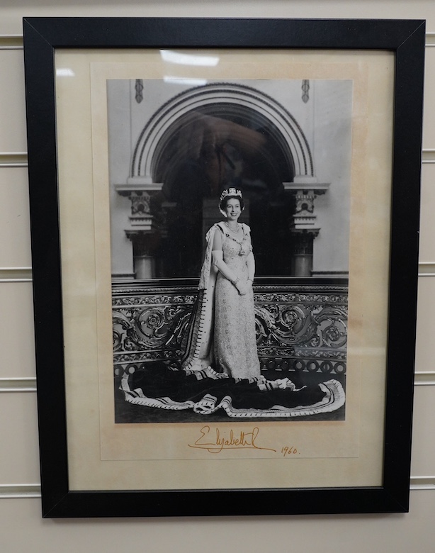 A signed photograph of Queen Elizabeth II, dated 1960 and issued for display in a British Embassy overseas, signed in the mount, 30 x 20.5cm. Condition - good